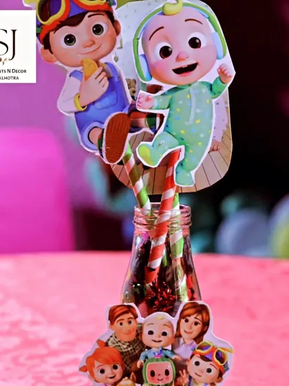 The little details matter. This image shows custom Cocomelon-themed toppers for drinks, adding to the immersive experience.