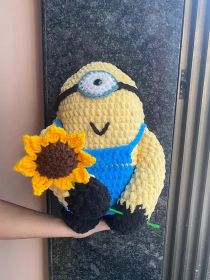 Another look at the plush Minion doll. The texture of this yarn is incredibly soft, making it a perfect sensory toy or a comforting friend.