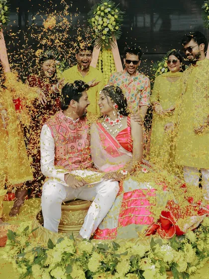 The beautiful chaos of Haldi. Surrounded by the laughter of friends and a storm of yellow petals, this is pure, unadulterated joy. I capture the energy and color of these traditions, preserving the fun that makes your story unique.