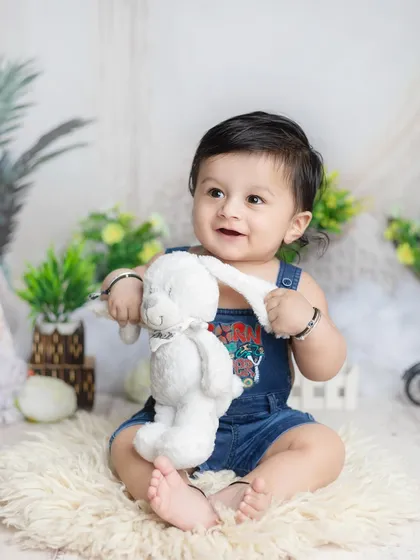 A sweet moment with a fluffy bunny toy. I have plenty of soft toys in the studio for babies to interact with.