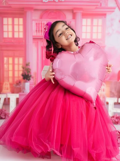 A joyful, candid moment from a Barbie-themed session. Her happy, toothy grin is what makes these creative shoots so special.