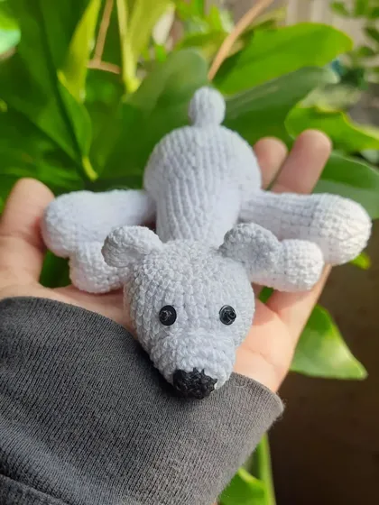 This big polar bear plushie is made with a soft, fuzzy yarn. It's a larger style of keychain, making it a fun and huggable accessory.