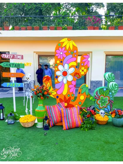 Another fun photo corner with a floral-painted cactus, a skeleton prop, and directional signs, offering guests multiple engaging photo opportunities.