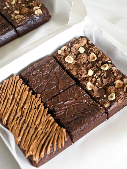 A close-up of my Assorted Brownies Box, a bestseller for Rakshabandhan. This box features a trio of my most loved flavors: rich Biscoff, classic Gooey Fudgy, and decadent Ferrero Rocher, all 100% eggless and freshly baked.