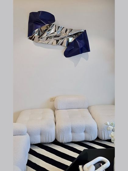 The finished installation, perfectly complementing the minimalist furniture and striped rug.