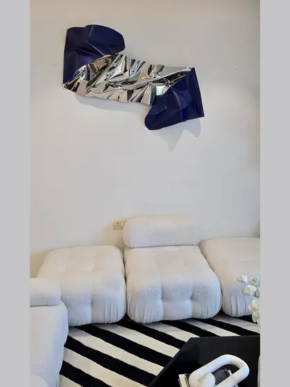 The finished installation, perfectly complementing the minimalist furniture and striped rug.
