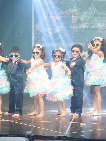 The kids strike a cool pose with their sunglasses, showing that style has no age limit.