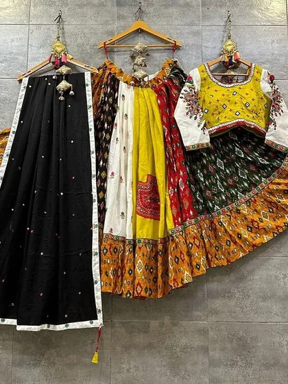 A vibrant and colorful lehenga with a unique patchwork design. The combination of yellow, red, green, and white makes this a truly eye-catching piece.