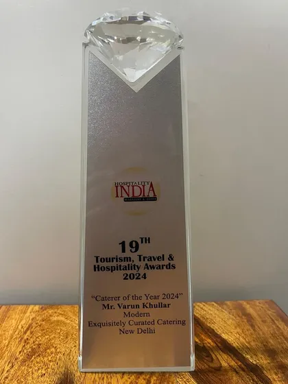 The 'Caterer of the Year 2024' trophy from the 19th Tourism, Travel & Hospitality Awards. A beautiful reminder of our commitment to excellence.