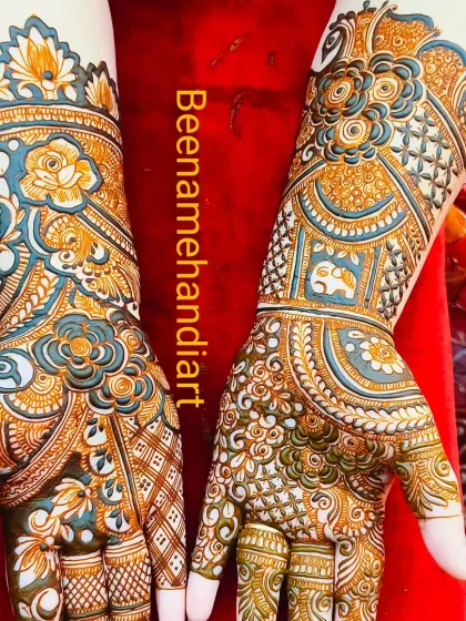 A beautiful and colorful full-hand design with floral, elephant, and paisley motifs.