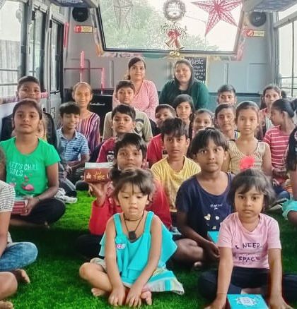 A group of children on our music bus during Christmas week, holding snacks generously provided by a supporter.