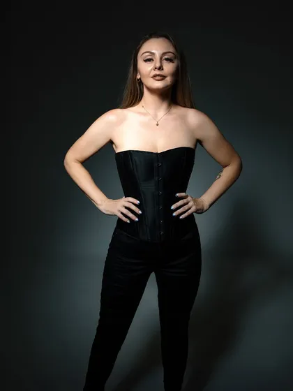 A powerful, full-body pose from a studio shoot, showing a confident and poised stance.