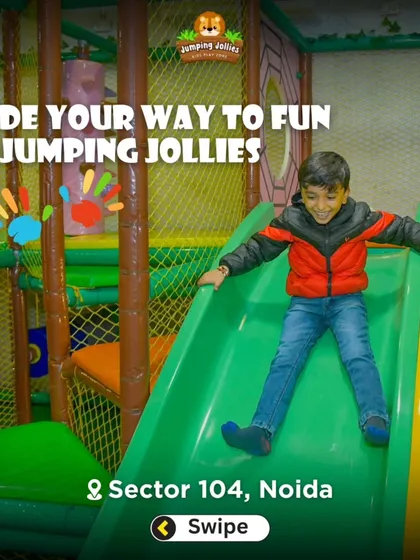 The text overlay says it all: "Slide your way to fun at Jumping Jollies." An action shot of a boy enjoying one of our main attractions.