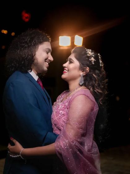 A beautiful candid of a couple looking at each other, with soft backlighting creating a romantic glow. We know how to use light to create magic.