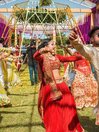 It's all about energy and expression. This shot captures the joy of a group Haldi dance, where everyone is in sync and having the time of their lives.