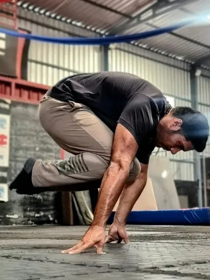 The tuck planche hold. It's about creating as much tension as possible through your arms, shoulders, and core to lift your body off the ground.