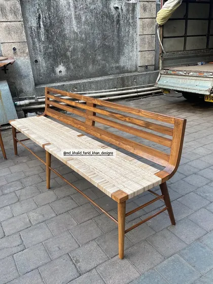 A single woven bench, showing its full length.