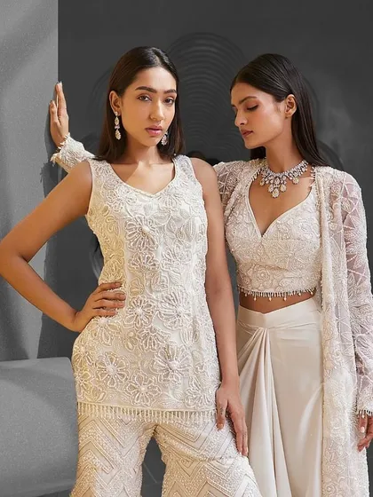 Impeccable silhouettes with intricate craftsmanship. These ivory ensembles from Istya are perfect for the festive season, offering a look of pure elegance.
