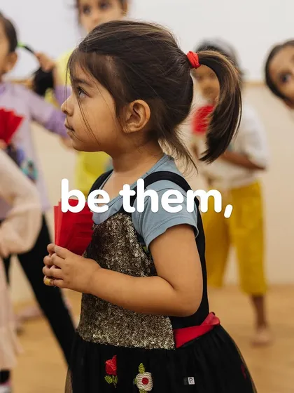 A focused young girl in a group, showcasing the quiet determination that leads to great things.