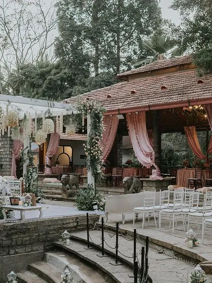 The Pond Pavilion set up for a pastel-themed wedding, with elegant draping and a beautiful mandap overlooking the water.