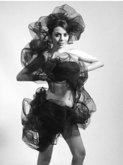An artistic exploration of draping with sheer, monochrome fabric. In my workshops, we learn to play with texture, light, and form to create ethereal and abstract fashion statements like this one.