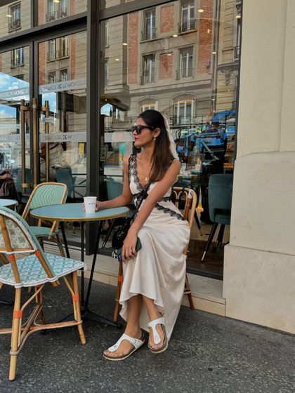 Taking a coffee break at a classic Parisian cafe. This is part of the quintessential travel experience, and my outfit feels right at home in this setting.