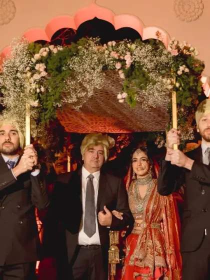 Family is at the center of every wedding. Here, the bride is escorted by her father and brothers, a beautiful blend of Lebanese and Indian traditions under a canopy of fresh baby's breath.