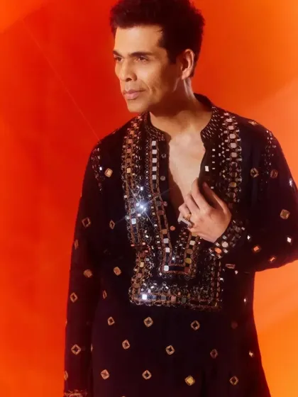 A celebrity-styled black kurta featuring intricate mirror work around the neckline, perfect for a high-glam festive event.