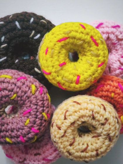 Happy Donut Day. A collection of colorful, calorie-free crochet donuts with sprinkles. These make fun play food for kids or a quirky desk decoration.