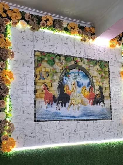 A complete look at the decorative wall frame in Tilak Nagar. The combination of the floral border, backlighting, and artificial grass wall creates a unique and personalized decor piece.
