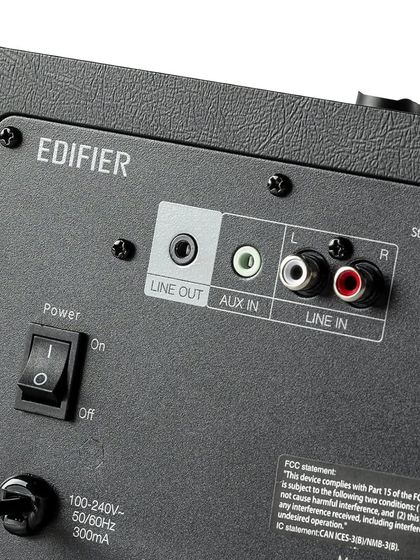 The back panel of the Edifier D12 shows its connectivity options, including Line In, Aux In, and a Line Out to add a subwoofer. This flexibility allows it to be integrated into various simple audio setups.