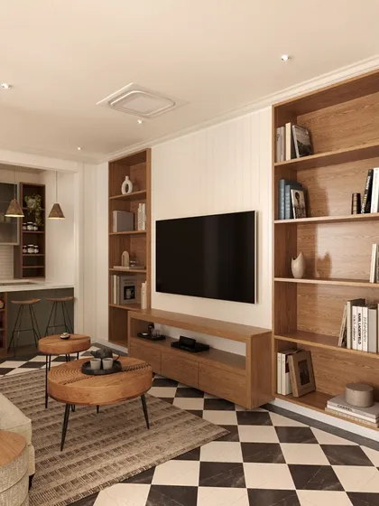 The lounge features floor-to-ceiling wooden bookshelves that provide ample storage and a warm, library-like feel. The comfortable seating and layered rugs make it the perfect spot for the family to relax.