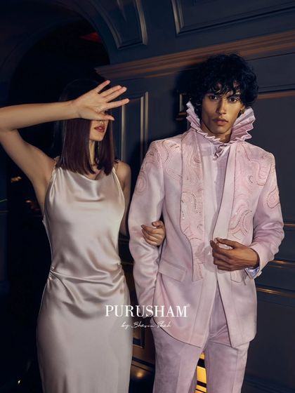 Lost in the allure of after-hours. This blush pink suit with its dramatic ruffled collar and delicate embroidery is designed to be unforgettable. It is a story of a night that turns into a cherished memory.