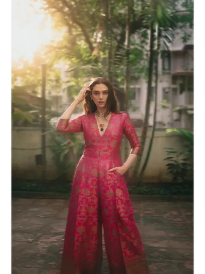 This pink brocade jumpsuit by Payal Khandwala is a favorite. It's a modern take on traditional fabric, creating a look that is both elegant and comfortable.
