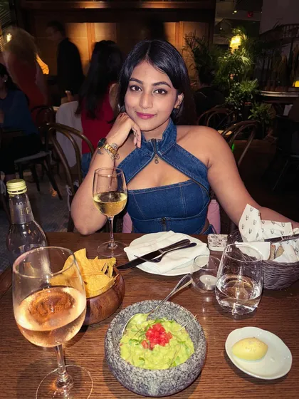Another shot from dinner, showing how the denim look works in a warm, ambient setting. It's a modern and stylish choice for an evening out.