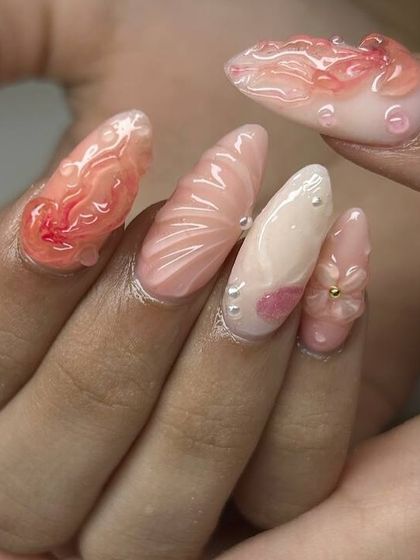 A stunning, ocean-inspired 3D nail art set. This design features sculpted shells, flowers, pearls, and water droplet effects in soft, beachy colors.