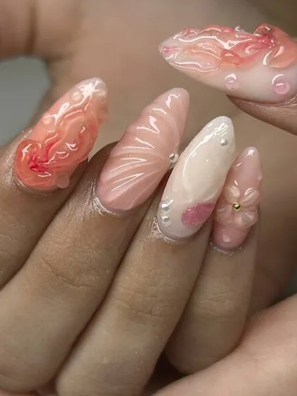 A stunning, ocean-inspired 3D nail art set. This design features sculpted shells, flowers, pearls, and water droplet effects in soft, beachy colors.