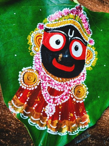 A brightly lit close-up of the finished Jagannath artwork. This angle highlights the fine details, from the delicate floral decorations in his crown to the shimmering gold accents on his clothing.