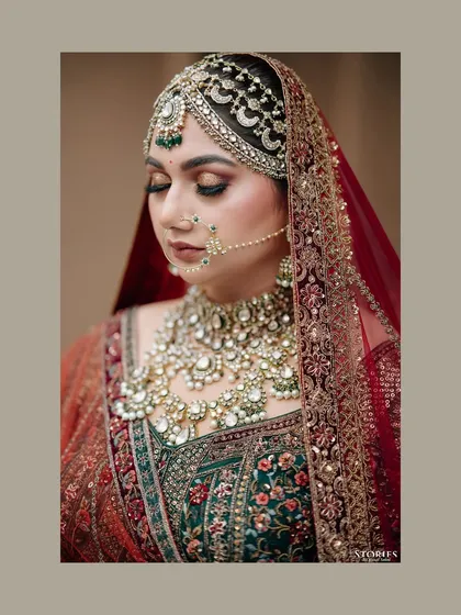 A close-up portrait of the bride, Rhea, showcasing her intricate bridal jewelry and flawless makeup.