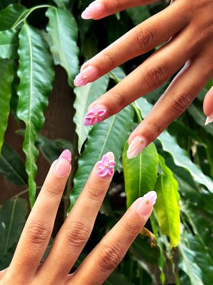 This artistic shot highlights the delicate, multi-dimensional aspect of the 3D floral nail art.
