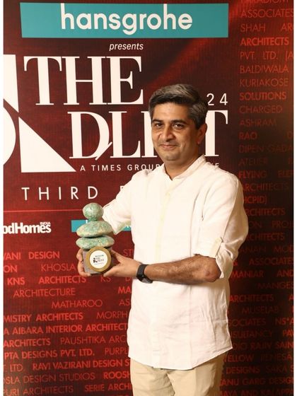 A portrait of our partner holding the D-List 2024 award, representing our firm's achievement.