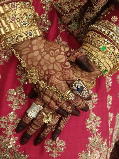 A candid shot of a bride's hands, adorned with my henna and beautiful wedding jewelry. I love capturing these real moments.