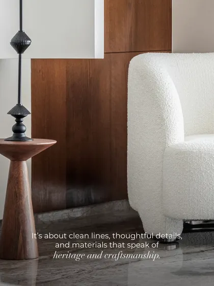 True elegance lies in restraint and the story of materials. This detail shot captures the essence of our philosophy: the soft texture of a bouclé armchair, the clean lines of a modern lamp, and the rich grain of a wooden side table. It is about creating a feeling of quiet, timeless luxury through thoughtful craftsmanship.