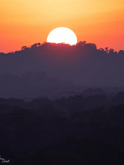 A little different from my usual wildlife photos, this is a minimalist landscape of a sunset in Singapore. The image focuses on the layers of the hills in silhouette and the powerful shape of the sun dipping behind the clouds.