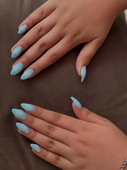 We love playing with color, as seen in this beautiful sky blue ombré design. The seamless gradient effect on elegantly shaped almond nails creates a soft yet modern look, perfect for adding a sophisticated pop of color to your style.