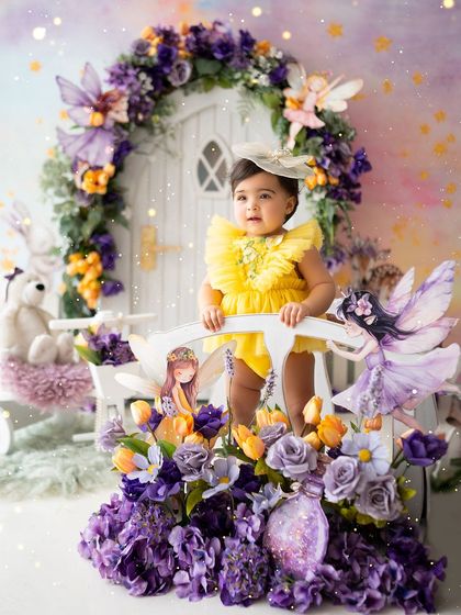 Standing on the bridge in her enchanted forest, surrounded by fairies and flowers.