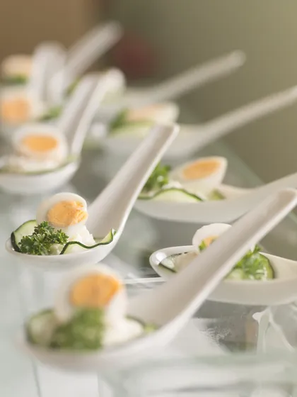 Elegance in a single bite. These appetizers, featuring quail eggs and fresh cucumber on ceramic spoons, showcase our refined approach to creating sophisticated hors d'oeuvres for luxury events.