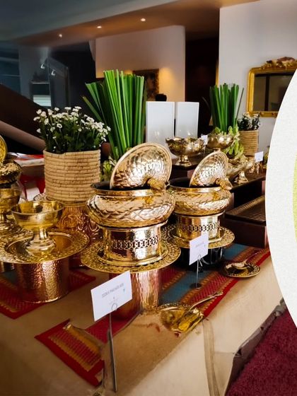 We create a divine culinary journey for festivals like Navratri. Our traditional buffet setup features authentic brass serving dishes, beautifully arranged on a rustic table.
