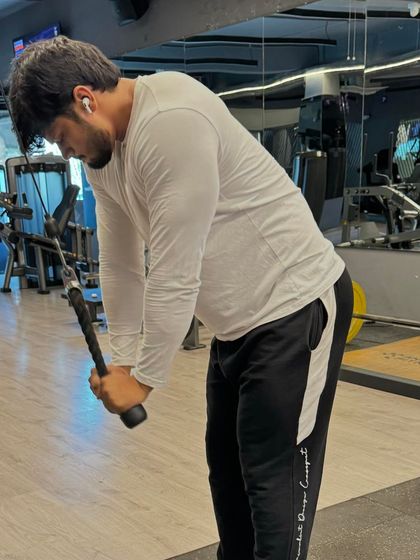 Another shot of the tricep pushdown, showing the proper form and engagement.