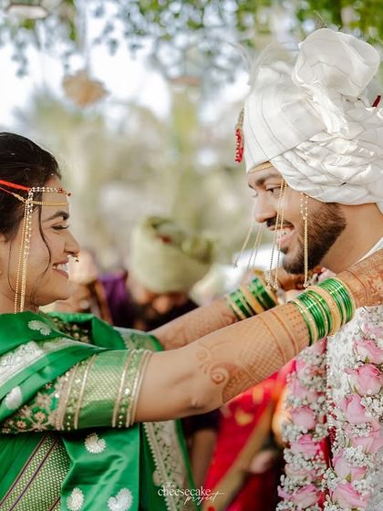 A tender moment as the bride helps the groom. These small interactions make a wedding special.